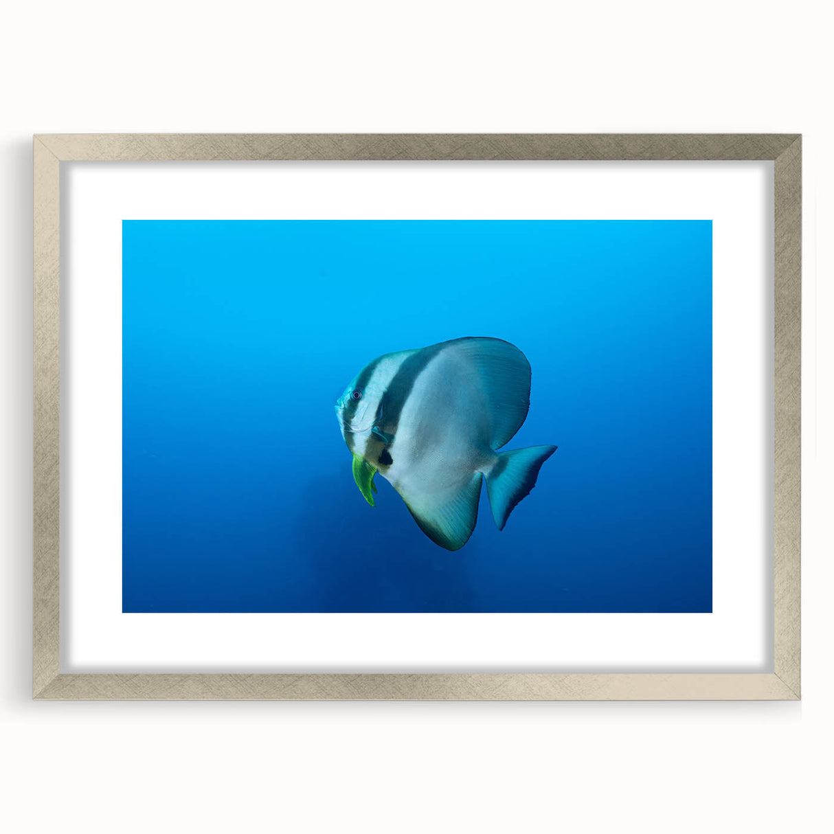 Textured abstract art print of an oceanic scene in cool blue and silver tones on a framed canvas, suitable for bedroom decor.