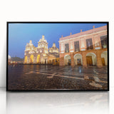 Large abstract wall art depicting a stylized scene of South America in muted earth tones, framed in black acrylic.