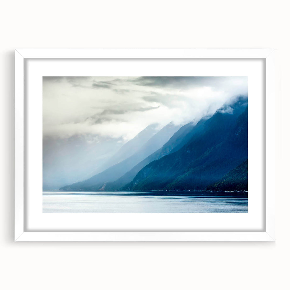 Abstract art print of Alaskan scenery in muted blue and white tones on a framed poster, ideal for dining room decor.