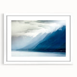 Abstract art print of Alaskan scenery in muted blue and white tones on a framed poster, ideal for dining room decor.