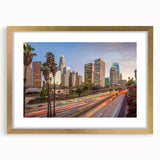 Extra large abstract art print of Los Angeles skyline in muted gold and blue tones on a framed canvas.