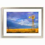 Textured abstract art print depicting Kansas scenery in muted earth tones, framed in silver, ideal for bedroom decor.