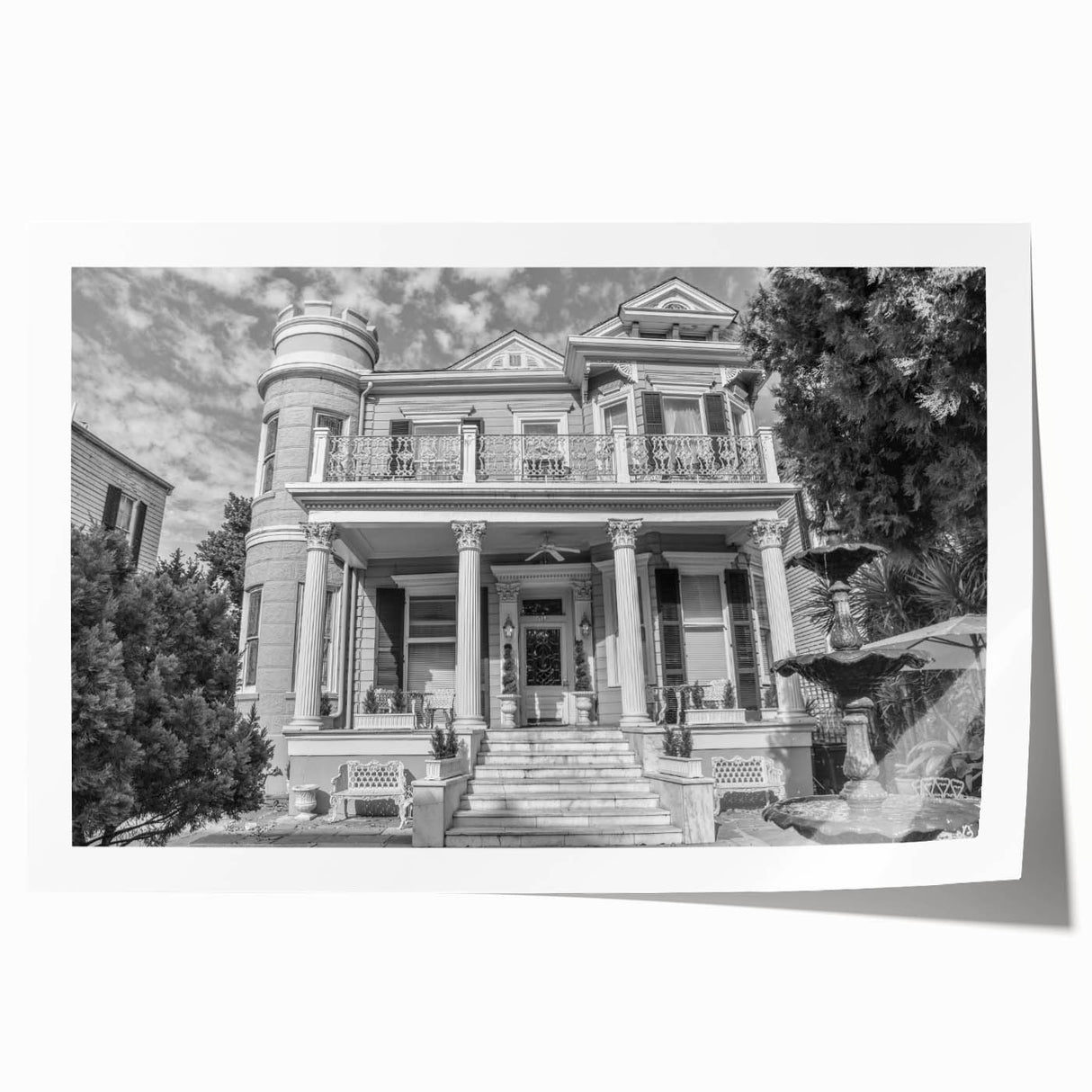 Rolled print of New Orleans scenery with vibrant green and pink floral elements, ideal for dining room wall art.