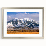 Textured abstract art print of Montana scenery in muted earth tones on a framed canvas, suitable for bedroom decor.