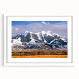 Abstract art print of Montana landscape in muted earth tones on a framed white mat, ideal for dining room decor.