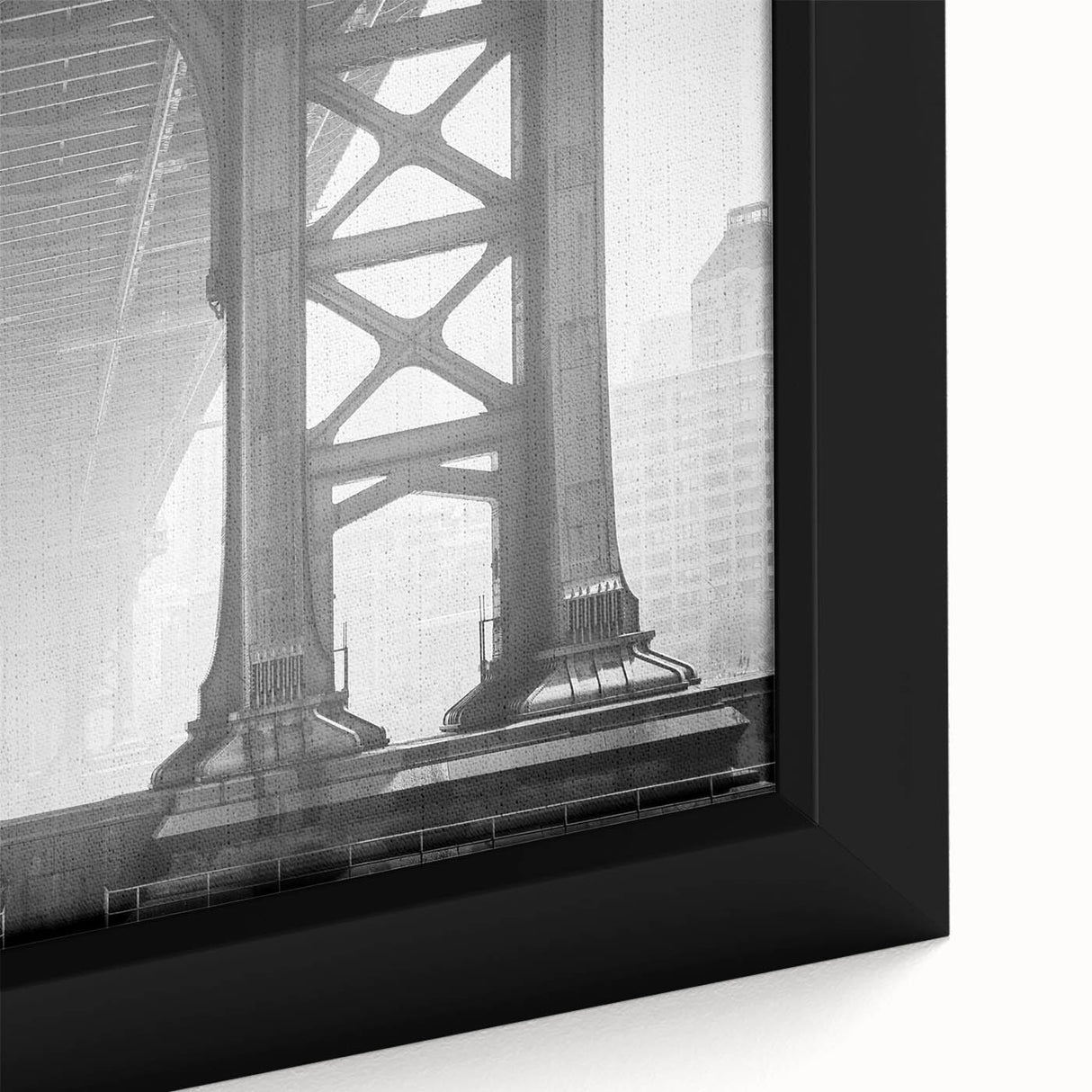 Close-up of a black wall art featuring the Brooklyn Bridge, with colorful, textured art on a framed canvas.