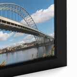 Close-up of a textured black wall art depicting Portland, Oregon scenery with colorful accents on a framed canvas.