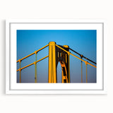 Abstract art print of Pittsburgh skyline in muted gray and blue tones on a framed white mat, ideal for dining room decor.