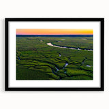 Colorful abstract art print of Charleston scenery in vibrant hues on a large framed canvas, ideal for living room decor.