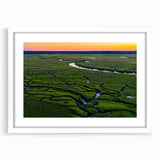 Abstract art print of Charleston scenery in muted earth tones on a framed white mat, ideal for dining room decor.