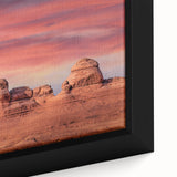 Close-up of a black-framed canvas depicting Arches National Park in Utah, featuring textured.