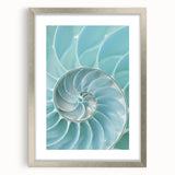 Textured abstract art print featuring swirling patterns in warm orange and red hues, framed in silver.