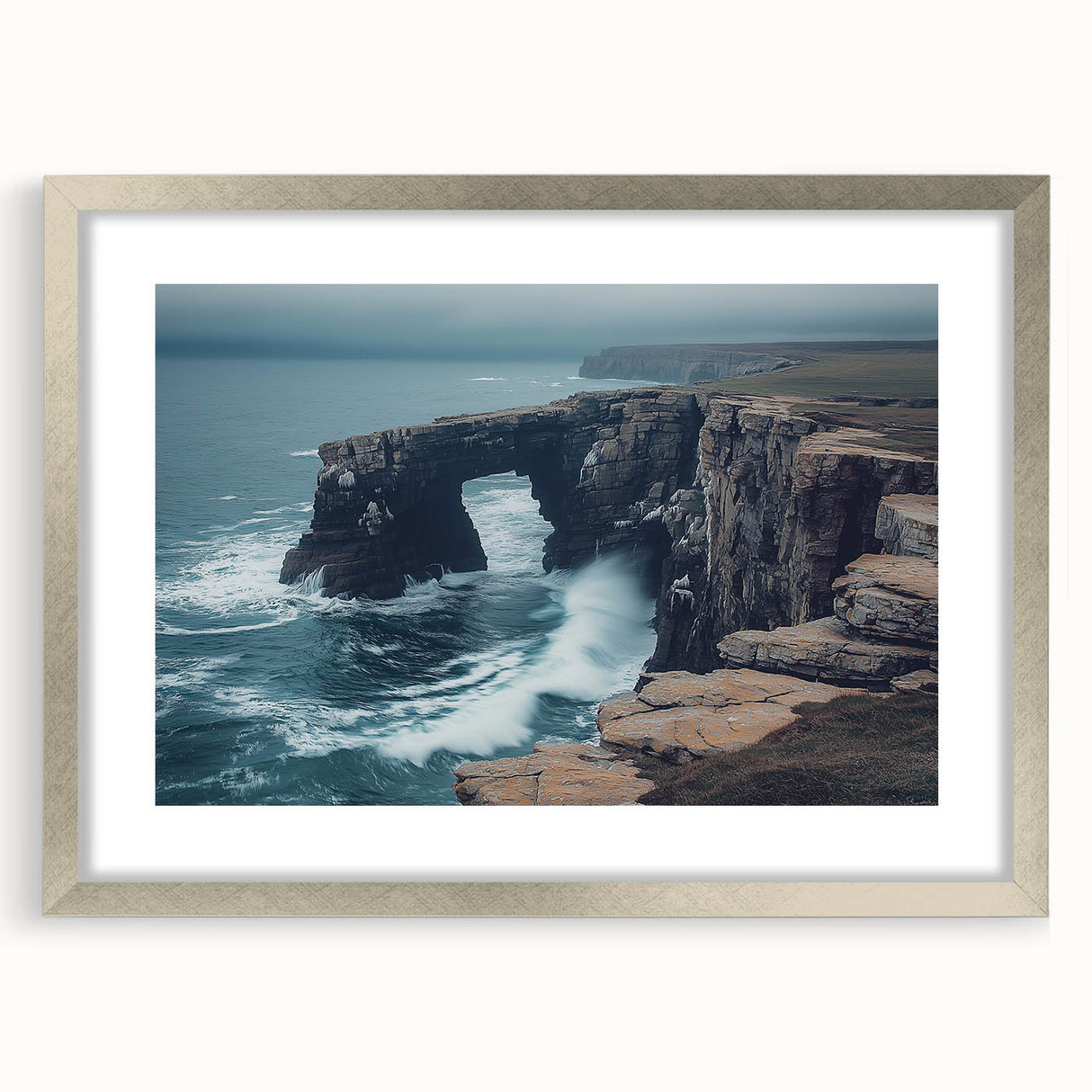 Silver-framed landscape print showcasing dramatic cliffs and serene ocean views, featuring a white mat for added elegance, perfect for modern home decor.