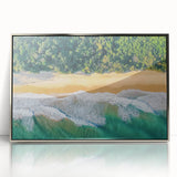 Framed acrylic artwork depicting a serene beach landscape with gentle waves and a vibrant sunset, featuring silver frame accents, ideal for modern home decor.