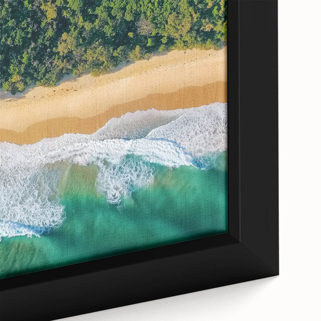Close-up of a framed landscape canvas print showcasing a serene beach scene with soft waves, vibrant blues, and warm sunset hues, perfect for coastal decor.