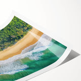 Vibrant landscape print showcasing a serene beach scene with soft waves and golden sand, rolled and secured in a protective cardboard tube for shipping.