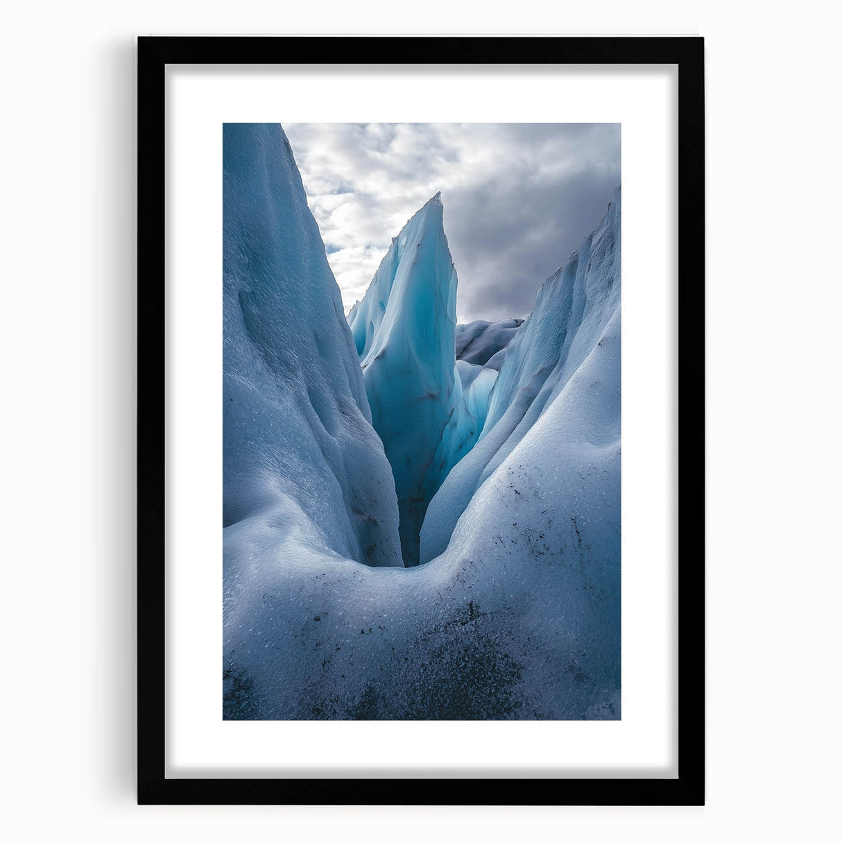 Framed landscape artwork showcasing a dramatic cliffside view, presented in a sleek black frame with a white mat, perfect for enhancing modern decor.