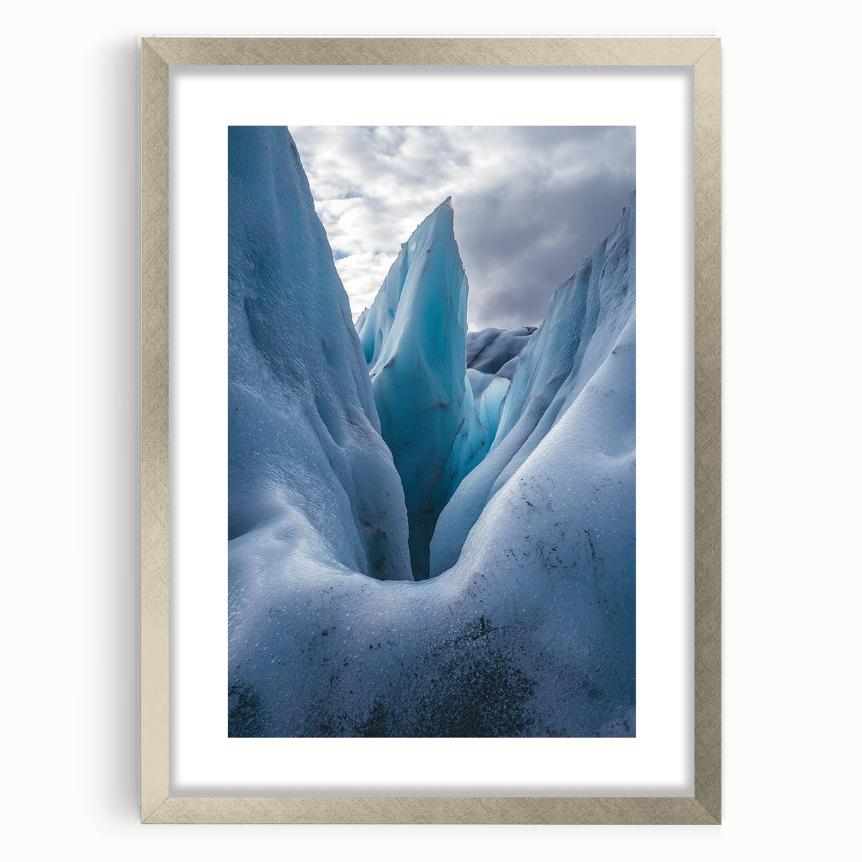 Framed landscape artwork depicting majestic cliffs in a silver mat, showcasing nature's beauty with vibrant colors, perfect for home decor.