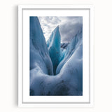 Framed landscape artwork depicting rugged cliffs under a serene sky, featuring a white mat and sleek black frame, ideal for enhancing modern home decor.