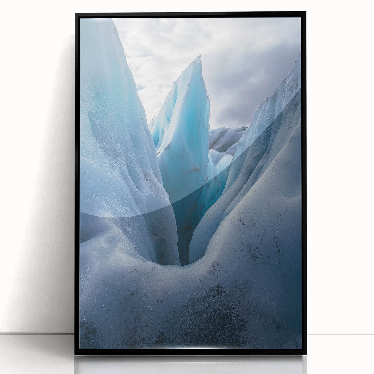 Framed acrylic artwork showcasing a dramatic landscape of cliffs against a vibrant sky, featuring black framing that enhances the visual depth and detail of the scene. Perfect for modern home decor.