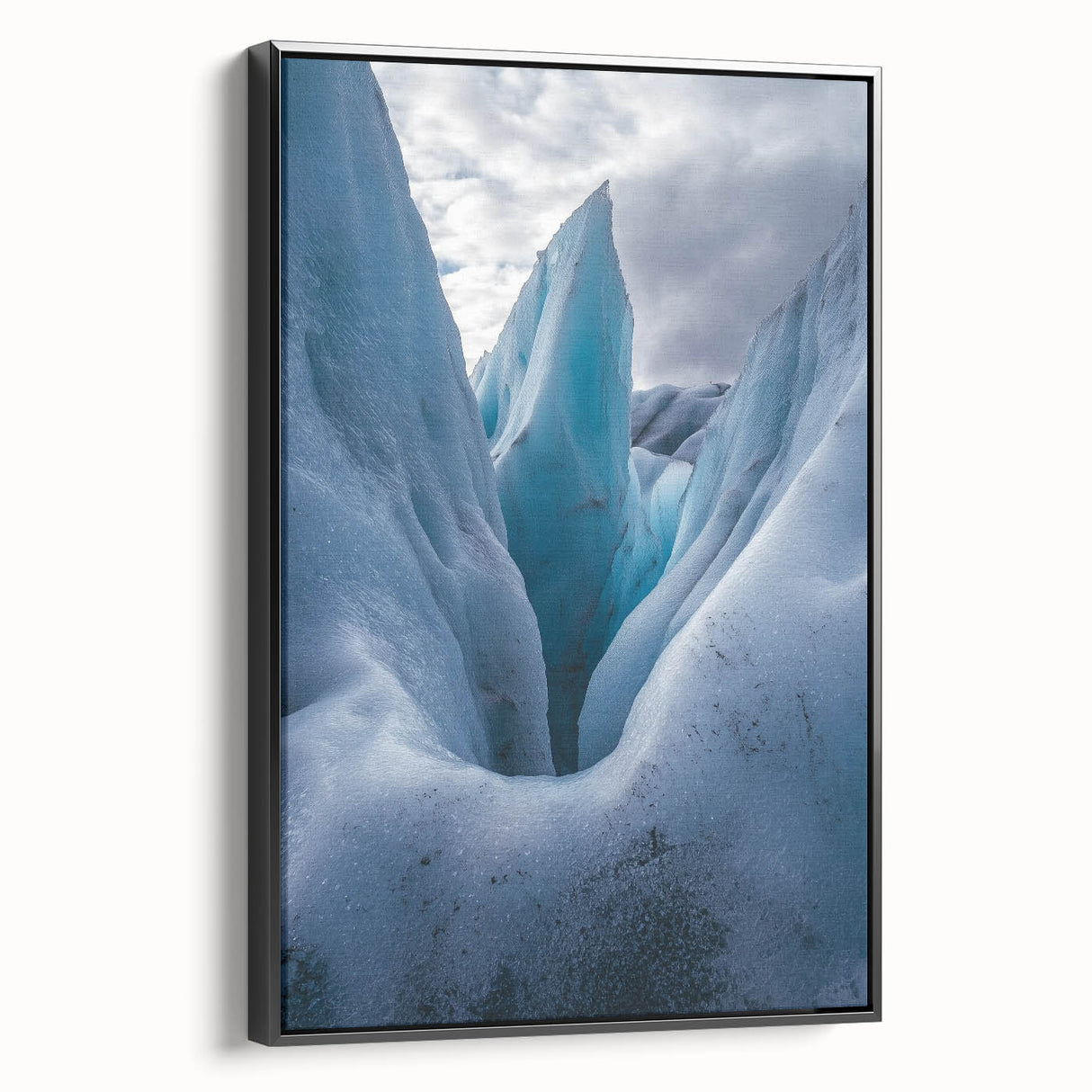 Framed canvas artwork depicting dramatic cliffs in a landscape scene, showcasing vibrant colors and fine details, presented in a sleek black frame for modern decor.