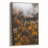 Framed canvas depicting a vintage landscape painting with fall foliage in muted gold and black tones.