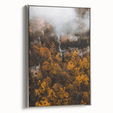 Framed canvas depicting a vintage-style landscape art painting with colorful autumn trees and a black background.