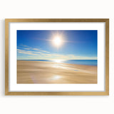 Elegant gold-framed landscape art featuring serene beach scenery with soft waves and a clear blue sky, perfect for home decor and coastal themes.
