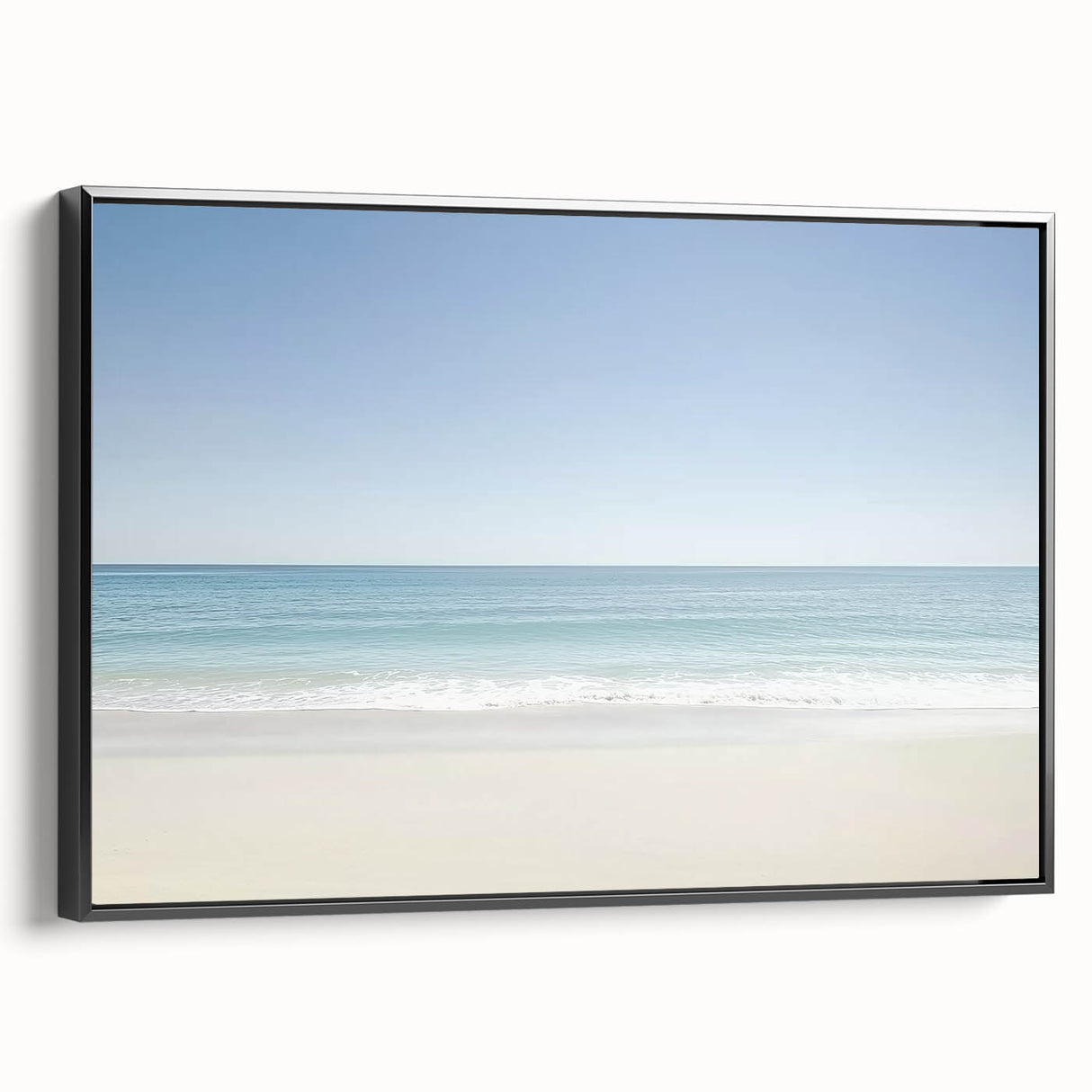 Framed landscape canvas artwork depicting a serene beach scene with gentle waves and soft sandy shores, presented in a sleek black frame, ideal for home decor.