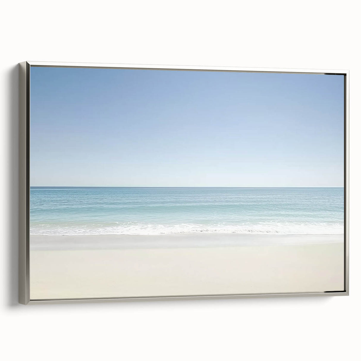 Framed landscape canvas art depicting tranquil beaches with soft waves, featuring a sleek silver frame, ideal for enhancing coastal-themed decor in homes or offices.