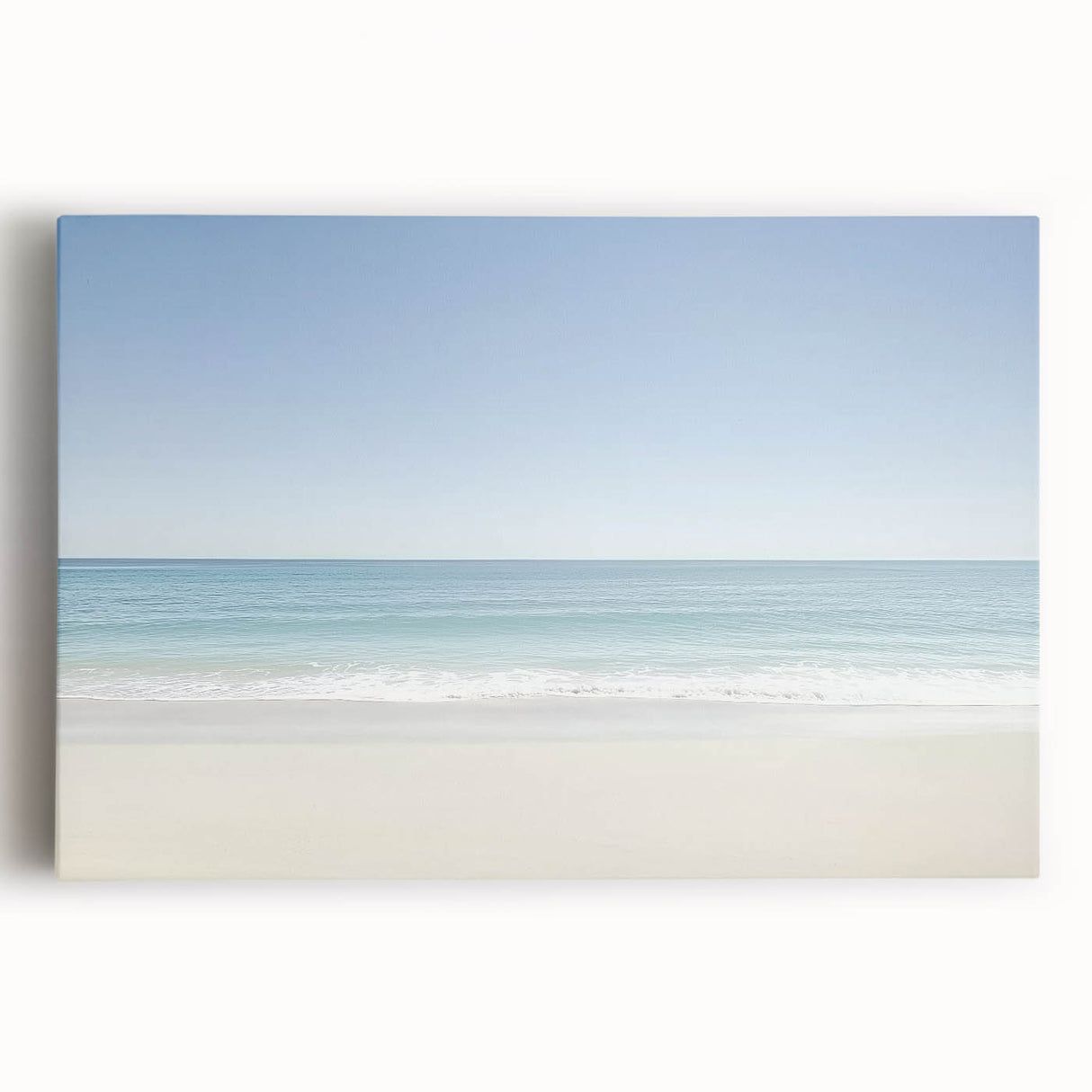 Stretched canvas artwork depicting a serene beach landscape at sunset, showcasing vibrant colors of orange and pink in the sky, with gentle waves lapping at the shore. Ideal for coastal home decor enthusiasts looking to enhance their living spaces.