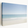 Stretched canvas artwork depicting a serene beach landscape with vibrant blue skies and golden sands, ideal for coastal home decor. Perfect for adding a tranquil touch to living spaces.