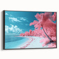Framed canvas artwork depicting a serene beach landscape with vibrant colors, showcasing gentle waves and a clear sky, presented in a sleek black frame.