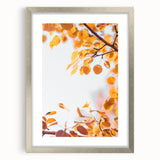 Textured abstract art print in autumn hues on a silver-framed canvas, ideal for bedroom wall decor.
