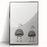 Mid-century modernist art depicting abstract shapes in muted orange and blue tones on a framed acrylic print.