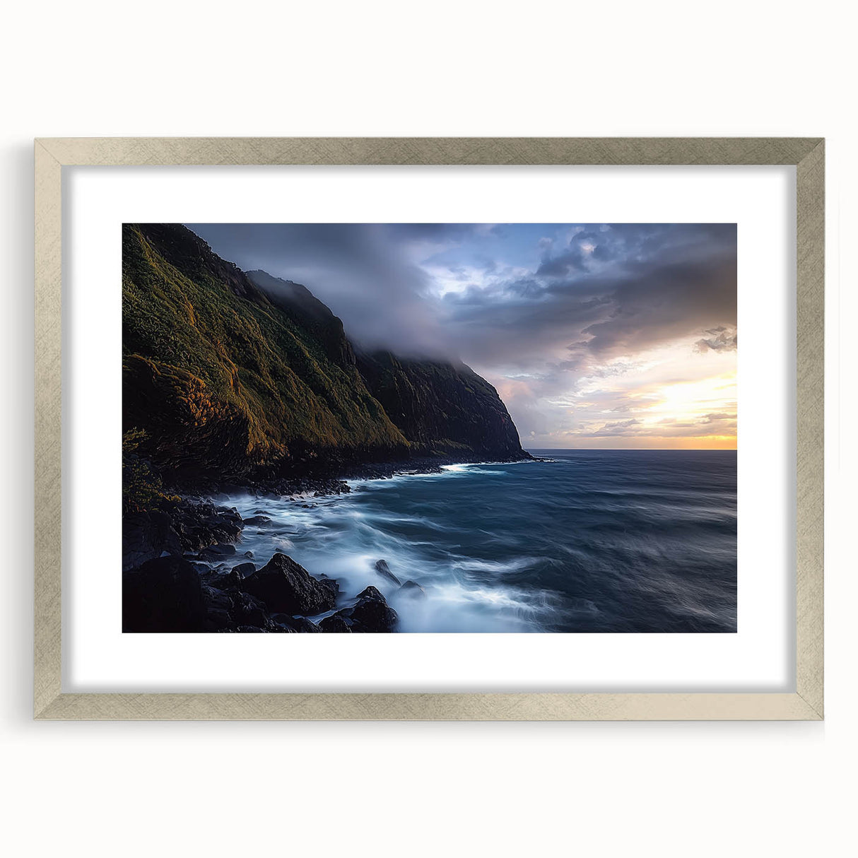 Silver-framed landscape art depicting dramatic cliffs, enhanced with a white mat, showcasing a serene natural scene ideal for home decor.
