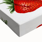 Close-up of a large art piece depicting various fruits in black and white tones on a stretched canvas.