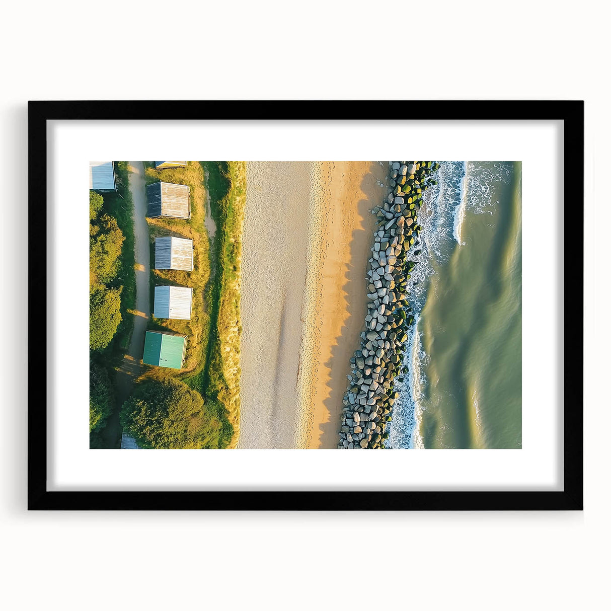 Black-framed landscape artwork featuring serene beach scene with a mat, ideal for home decor. Perfect for adding a coastal touch to any room.