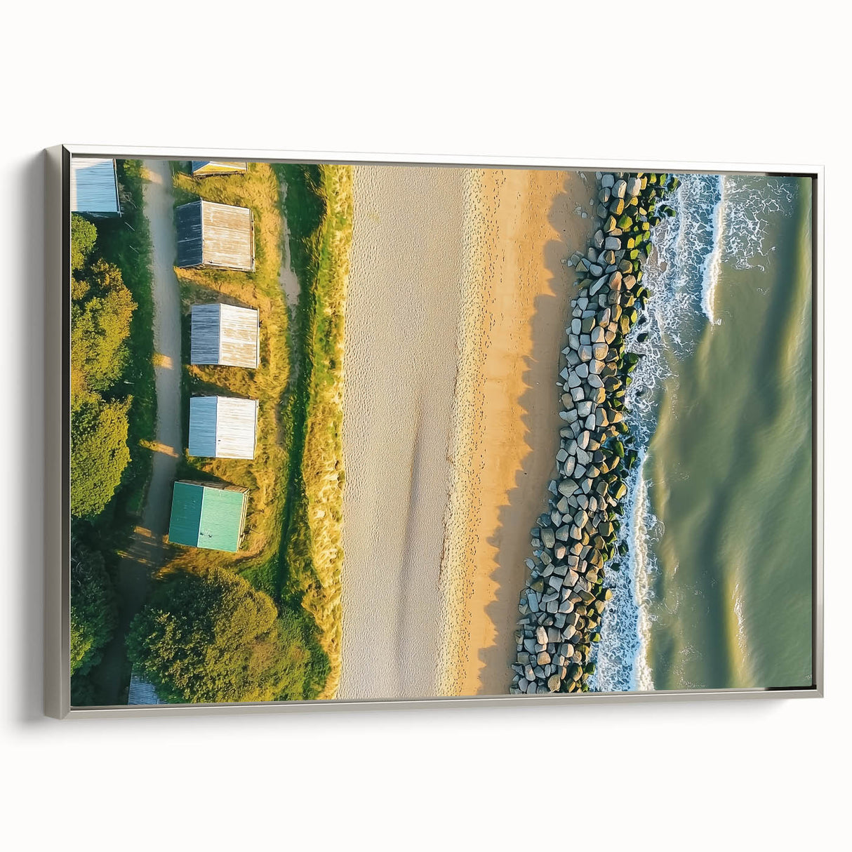Framed canvas artwork showcasing a serene beach landscape with vibrant colors, displayed in a sleek silver frame, ideal for enhancing home decor.