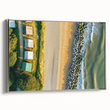 Framed canvas artwork showcasing a serene beach landscape with vibrant colors, displayed in a sleek silver frame, ideal for enhancing home decor.
