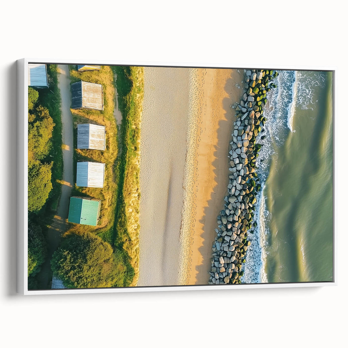 Framed canvas artwork depicting a serene beach landscape, featuring soft waves and blue skies, displayed in a sleek white frame for a modern touch. Perfect for coastal decor enthusiasts.