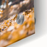 Large abstract wall art in warm autumn hues on acrylic glass, fitting for dining room ambiance.