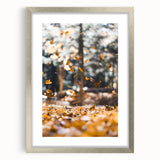 Textured abstract art print in warm autumn hues on a silver-framed canvas, suitable for bedroom decor.