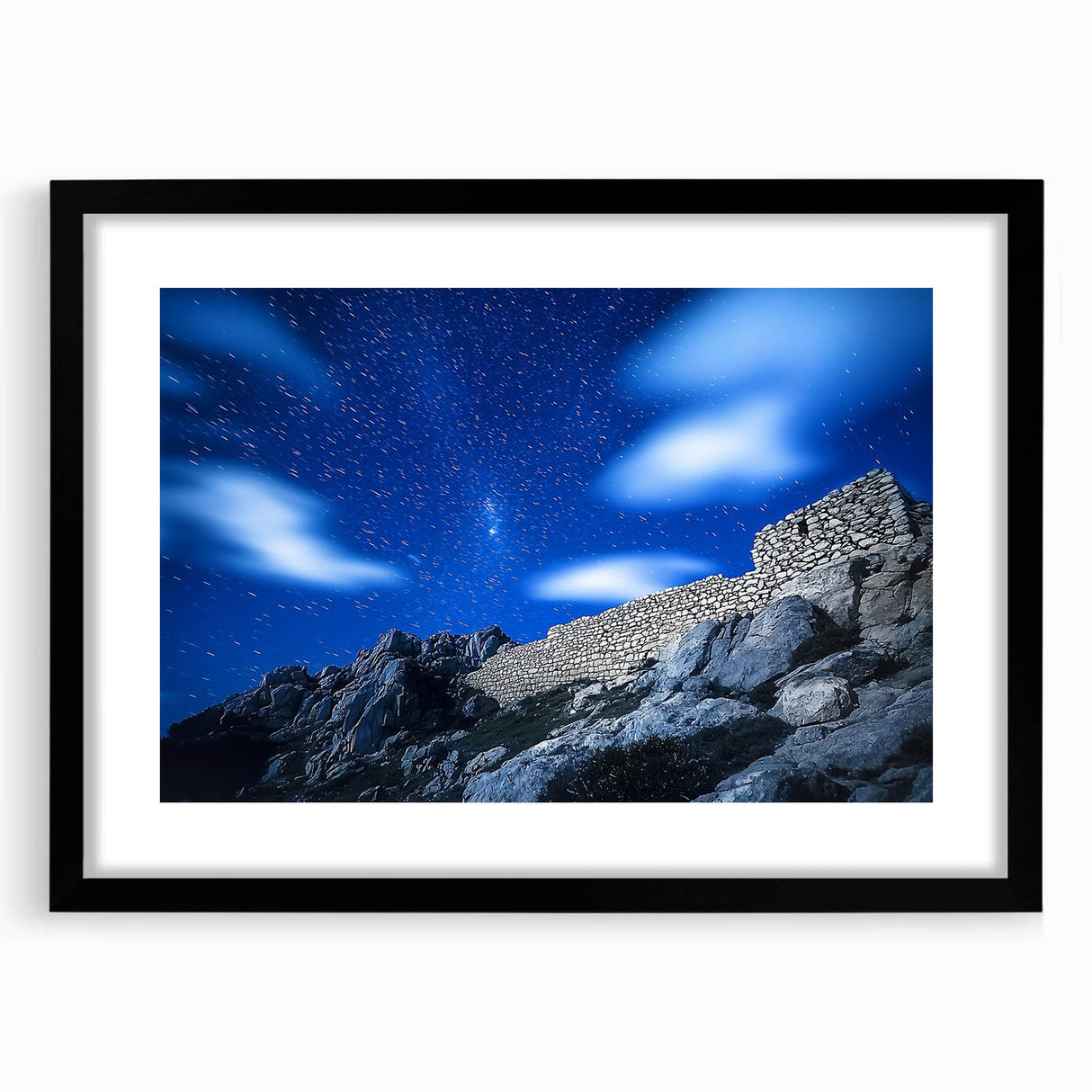 Framed landscape artwork depicting rugged cliffs with a black matting, showcasing detailed textures and natural hues, perfect for home decor and art enthusiasts.