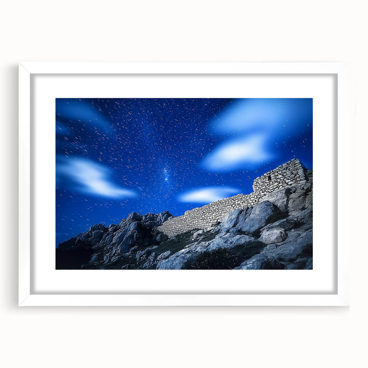 Framed landscape artwork depicting dramatic cliffs with vibrant colors, featuring a white mat and sleek design, perfect for modern home decor. This piece adds depth and elegance to any space.