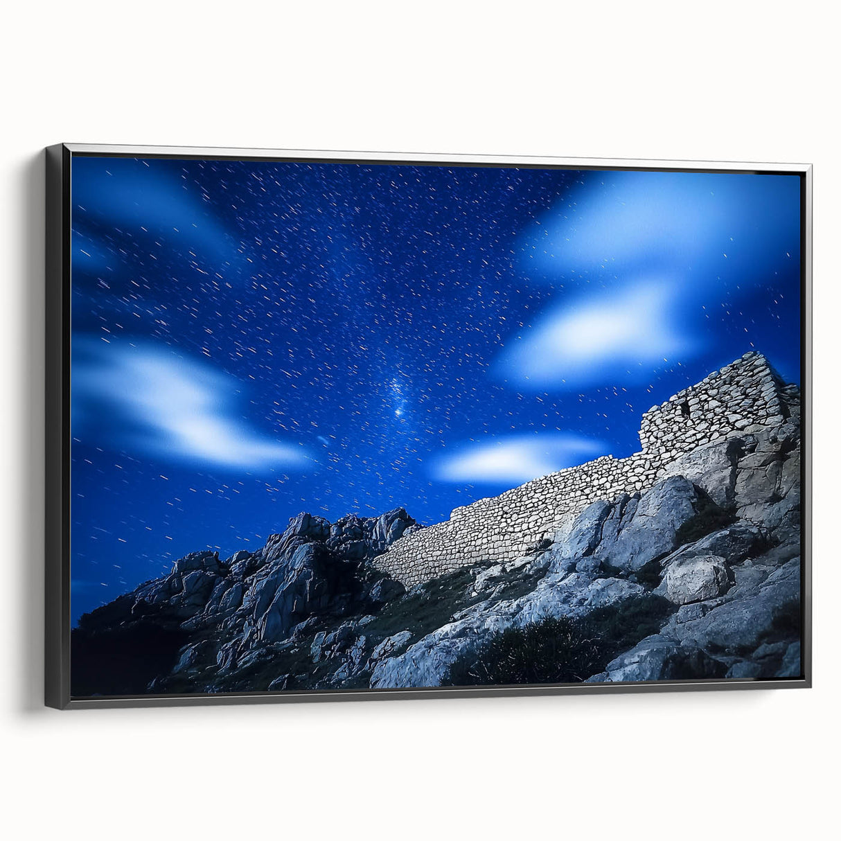 Framed canvas artwork showcasing a stunning landscape with dramatic cliffs, presented in a sleek black frame, perfect for enhancing home decor aesthetics.