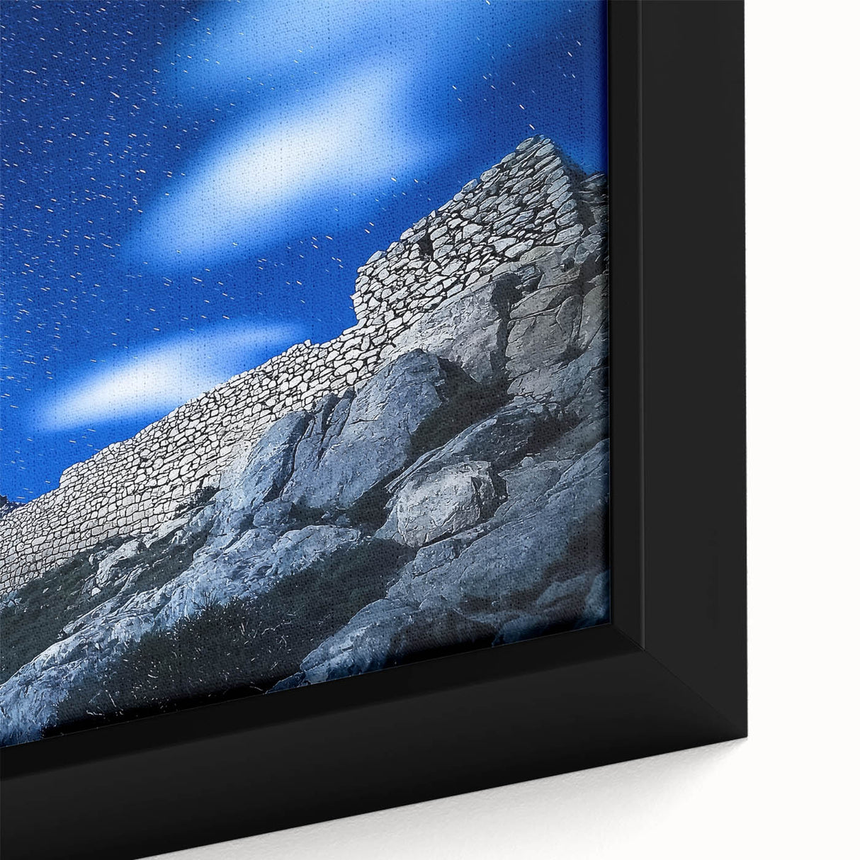 Close-up of a framed canvas artwork depicting a vibrant landscape with dramatic cliffs and a serene sky, showcasing rich colors and intricate details, perfect for enhancing home decor.