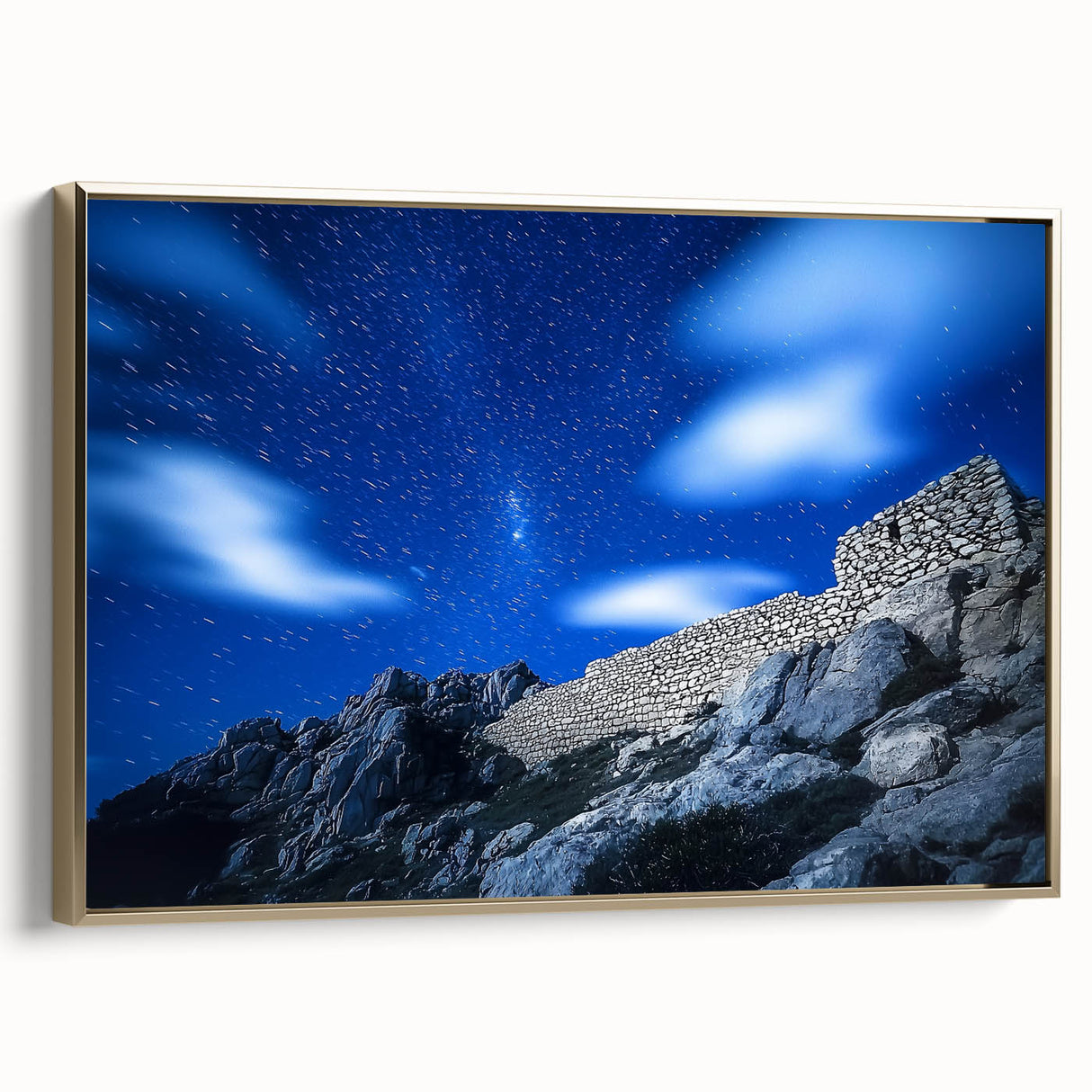 Framed canvas artwork showcasing a stunning landscape of cliffs, elegantly bordered with a gold frame, ideal for enhancing home decor and interior aesthetics.