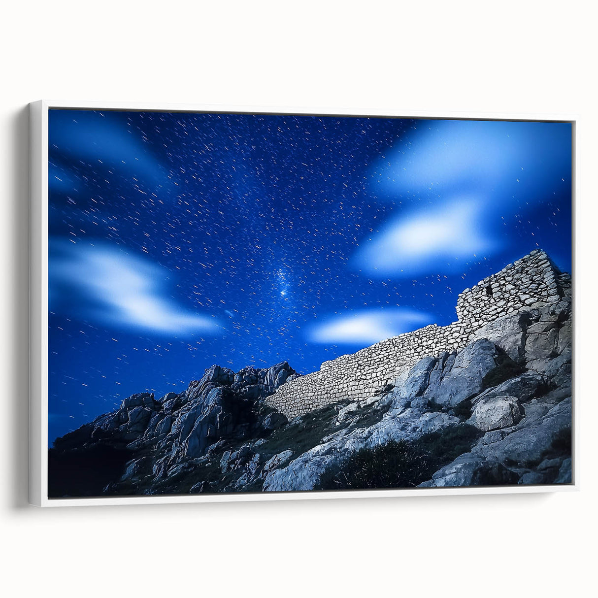 Framed canvas artwork showcasing a stunning landscape with towering cliffs and vibrant colors, set against a serene sky, ideal for home decor enhancement.