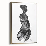 Framed abstract figurative canvas artwork with a gold border, showcasing intricate designs and vibrant colors, displayed in a stylish side view against a neutral background.